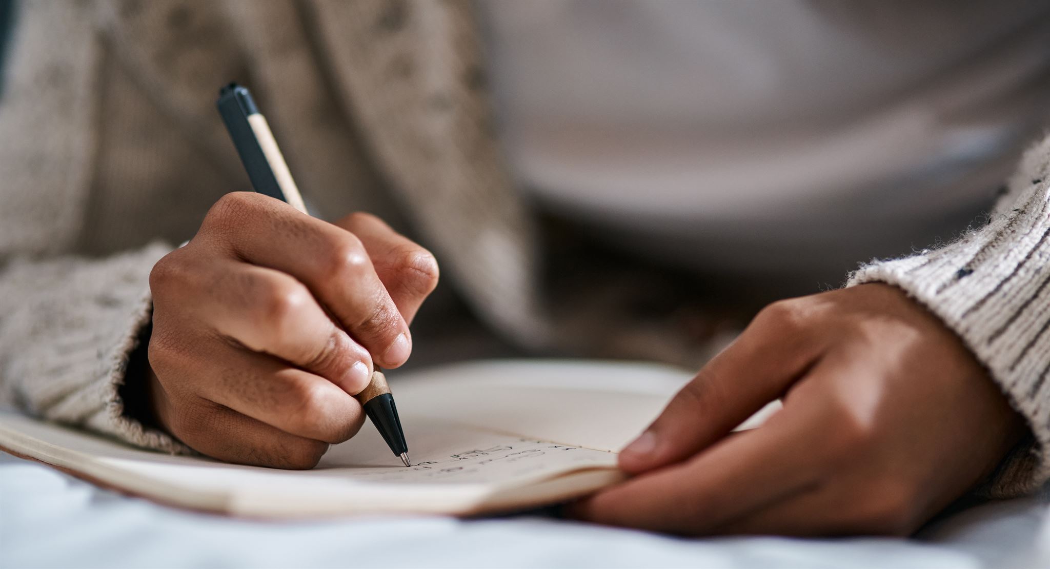 Person-writing-on-notebook